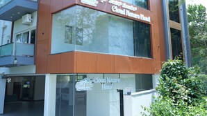 A hotel with a modern architectural design, featuring large glass windows and a prominent sign.