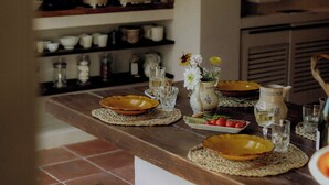 A kitchen with a wooden countertop, hanging pots, and a tiled floor. - Cozy and refined retreat in the heart of Fanjeaux (Fanjeaux)