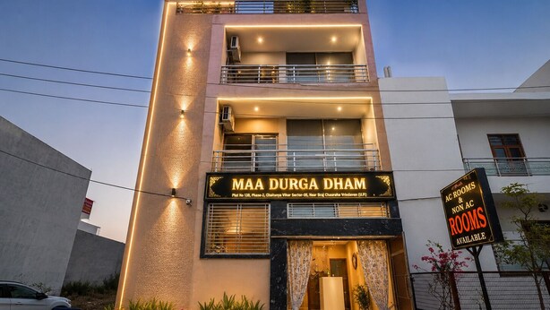 A multi-story building with a sign for 'MAA DURGA DHAM' indicating available AC and non-AC rooms. - Maa Durga Dham (Vrindavan)