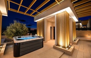 A modern outdoor hot tub area with a pergola structure, a large tree, and a well-lit entrance. - Awesome home in Smokovic with sauna (Smokovic)