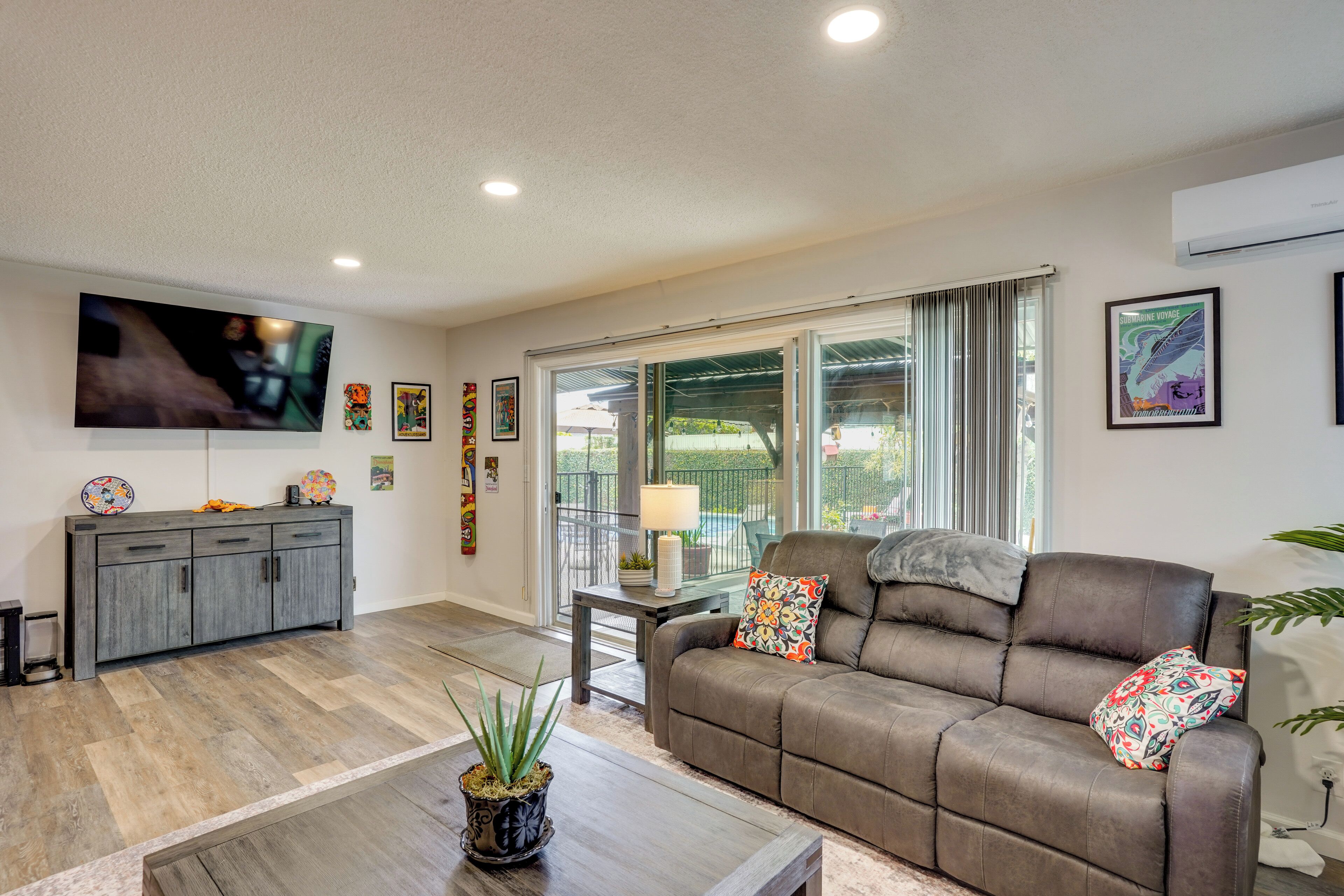 A living room with a sofa, a coffee table, a TV, and a cabinet.