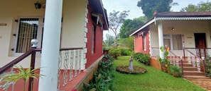 A residential property with a front garden, a staircase with a railing, and a small statue.