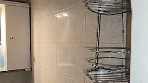 A bathroom with a shower, a sink, and a mirror. - Thessalonik Apartment-heart of City (Thessaloniki)