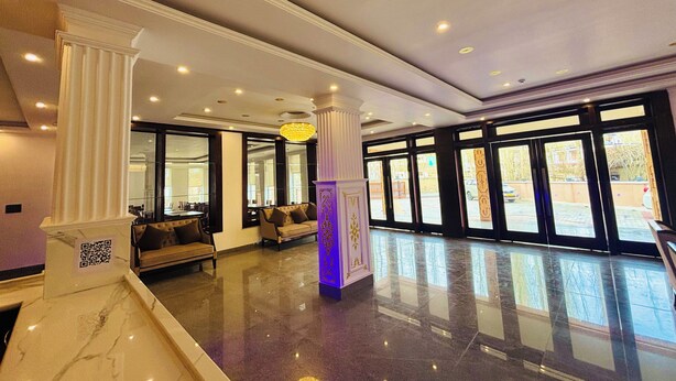 A spacious lobby with a marble floor, large windows, and a central seating area. - Hotel Dekiling by Eastlynn Collections (Leh)