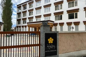 A multi-story hotel building with a traditional architectural style, featuring a prominent entrance gate and a signboard with the hotel's name. - Hotel Dekiling by Eastlynn Collections (Leh)