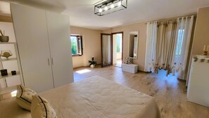 A spacious room with a large bed, a wardrobe, a mirror, and a window with curtains. -  NEW! Perfect for 2! Private Pool, mountain Views, covered terrace. Romance! (Toscana)