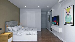 A modern bedroom with a bed, bedside table, and wall-mounted artwork. - Budget VictoryS Ensuite Room (Gibraltar)