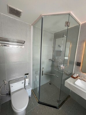 A modern bathroom with a glass-enclosed shower, a toilet, and a sink. - Hub Multi 3 Hotel (Phu Quoc)