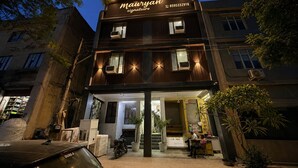 A building with a sign reading 'Mauryan Signature' and a contact number. - Mauryan Signature Hotel NHPC Metro (Faridabad)