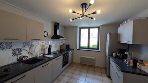 A kitchen with a central island, a window, and a built-in oven.