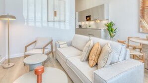 A modern living room with a sofa, chairs, a small table, and a floor lamp. - Modern studio, port view - 2 guests (Estepona)