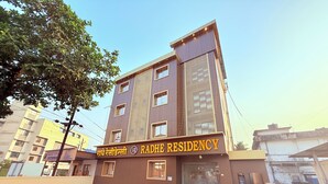 A multi-story building with a sign reading 'RADHE RESIDENCY.' - Radhe Residency MIDC Taloja  (Panvel)