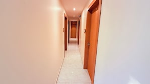 A corridor with doors on both sides, leading to a room. - Radhe Residency MIDC Taloja  (Panvel)
