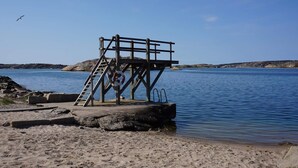 A lifeguard tower with a ladder, a lifebuoy, and a clear view of the water. - 4 Star Holiday Home in Tanumshede (Tanum)