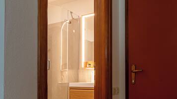 Shower, hair dryer, slippers, towels