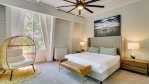 A bedroom with a bed, two bedside tables, a hanging chair, a bench, a ceiling fan, and a window with curtains. - Lakefront Bliss w/ Dock + Fire Pit! Ozarks Home (Osage Beach)