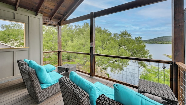 A covered outdoor area with wicker furniture and a view of a lake. - Fishing Dock & Mtn Views! Buchanan Lake Family Gem (Burnet)