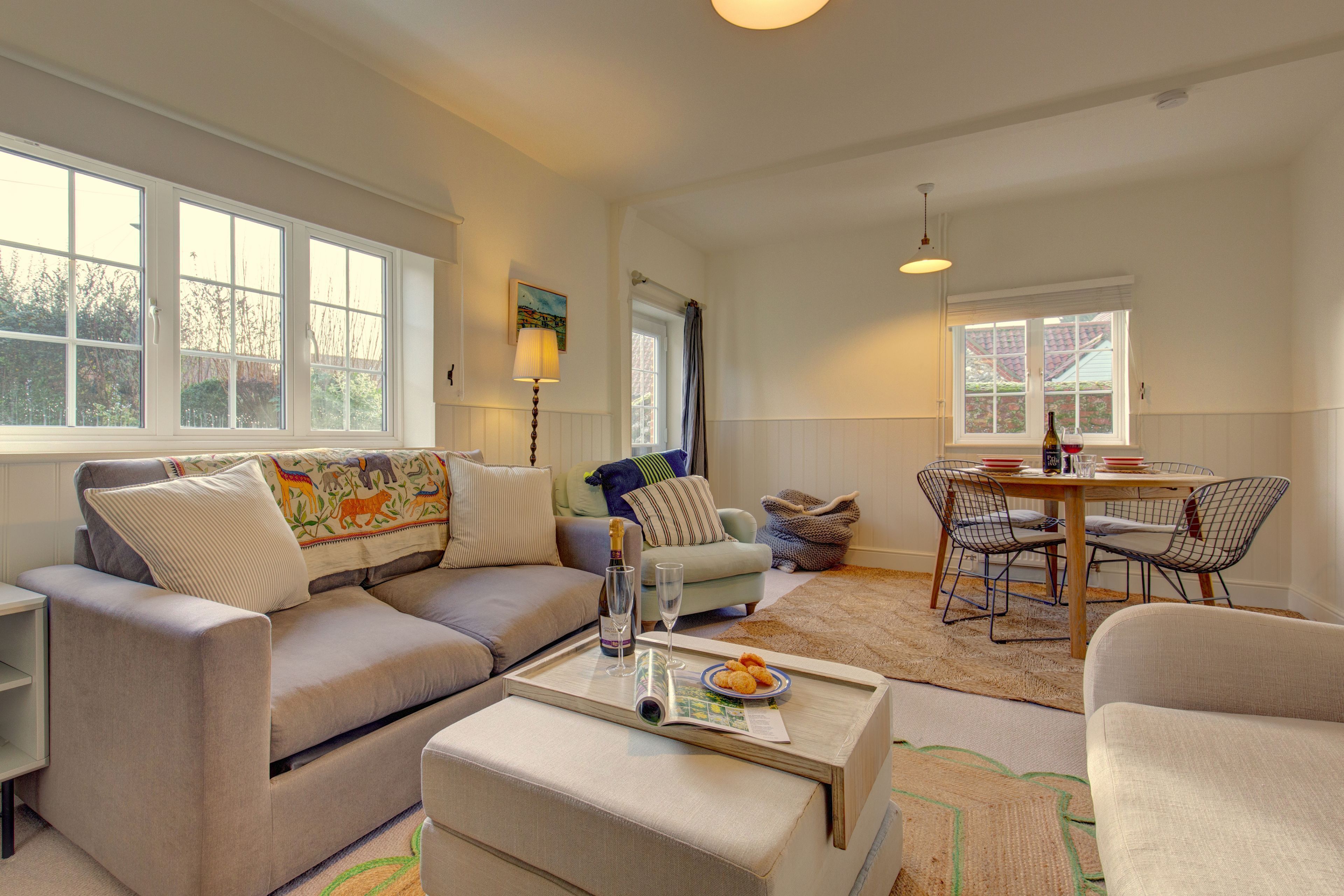 Ground floor: Sitting room/ dining room with a Smart television, cosy wood burning stove and dining table with setting for four guests