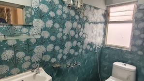 A bathroom with a sink, toilet, and shower. - REJOICE HOMESTAY  (Darjeeling)