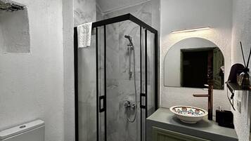 Deluxe Double Room, Courtyard View | Bathroom | Shower, hair dryer, slippers, towels