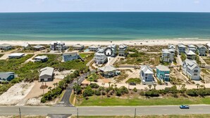 A coastal residential area with houses, a road, and a beach. - Private Pool - Gulf Views-Steps from the Beach (Cape San Blas)