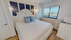 Una camera da letto con un letto, una finestra vista, un termosifone e una porta.
