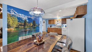 A dining area with a large table, chairs, and a decorative centerpiece. - Charming Home Near Lake Winnipesaukee Beach Access 3 Bedroom Home (Moultonborough)