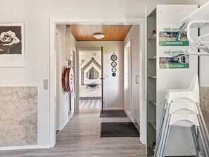 A hallway with a wooden ceiling, a mirror, a sink, and a door leading to a bathroom. - 20 Person Holiday Home in Norre Nebel (Norre Nebel)