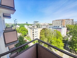 A residential area with apartment buildings, a clear sky, and a balcony railing. - Przy Klifie by Interhome (Warsaw)