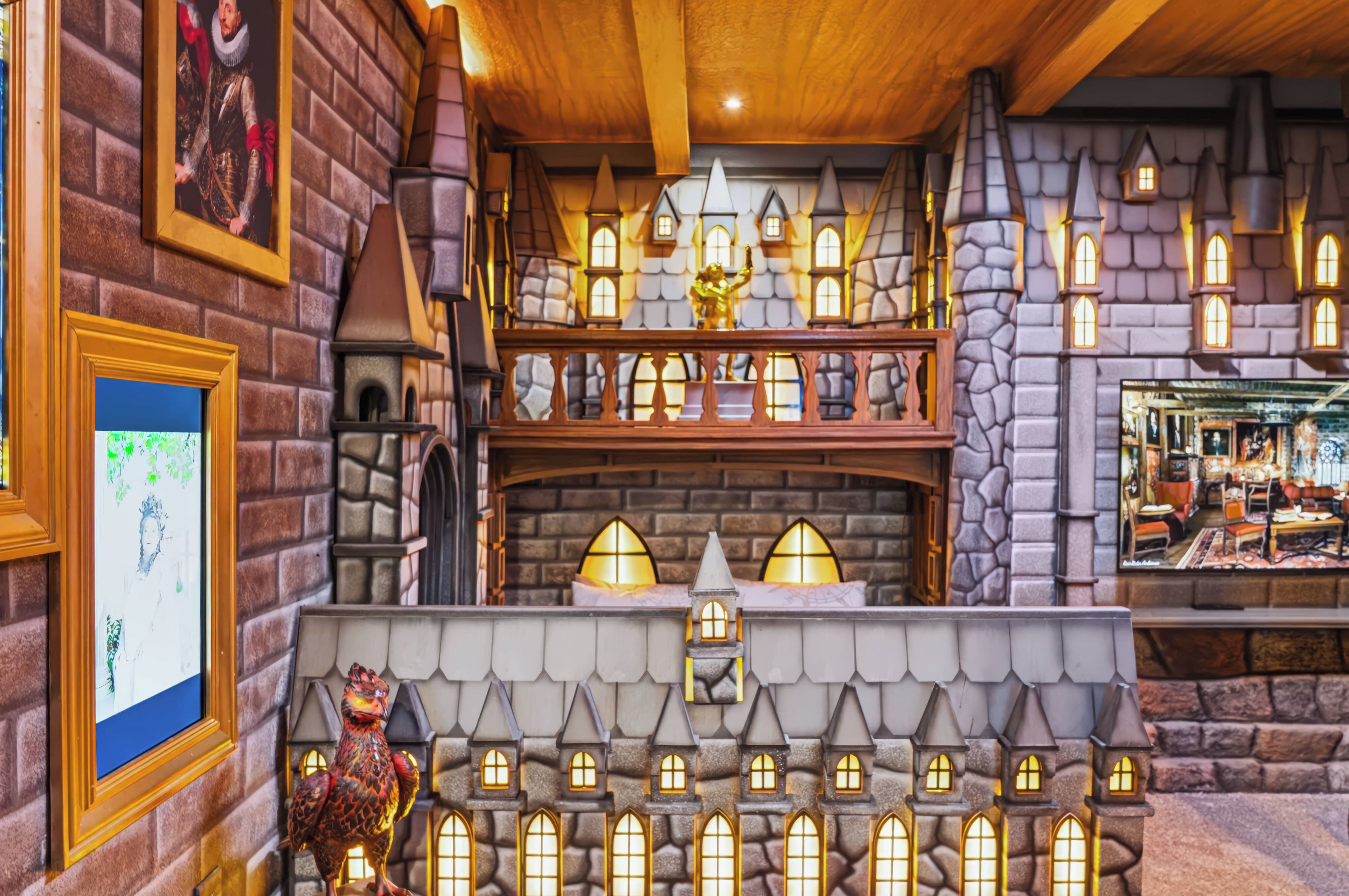 A model of a medieval-style building with multiple levels, stone walls, and a variety of windows.
