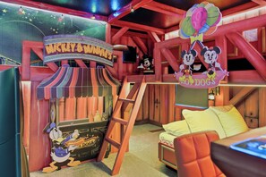 A Mickey & Minnie themed room with a sign, a Mickey Mouse figure, a ladder, and a bed. - 8BR house sleeps 22 near Disney area (Clermont)