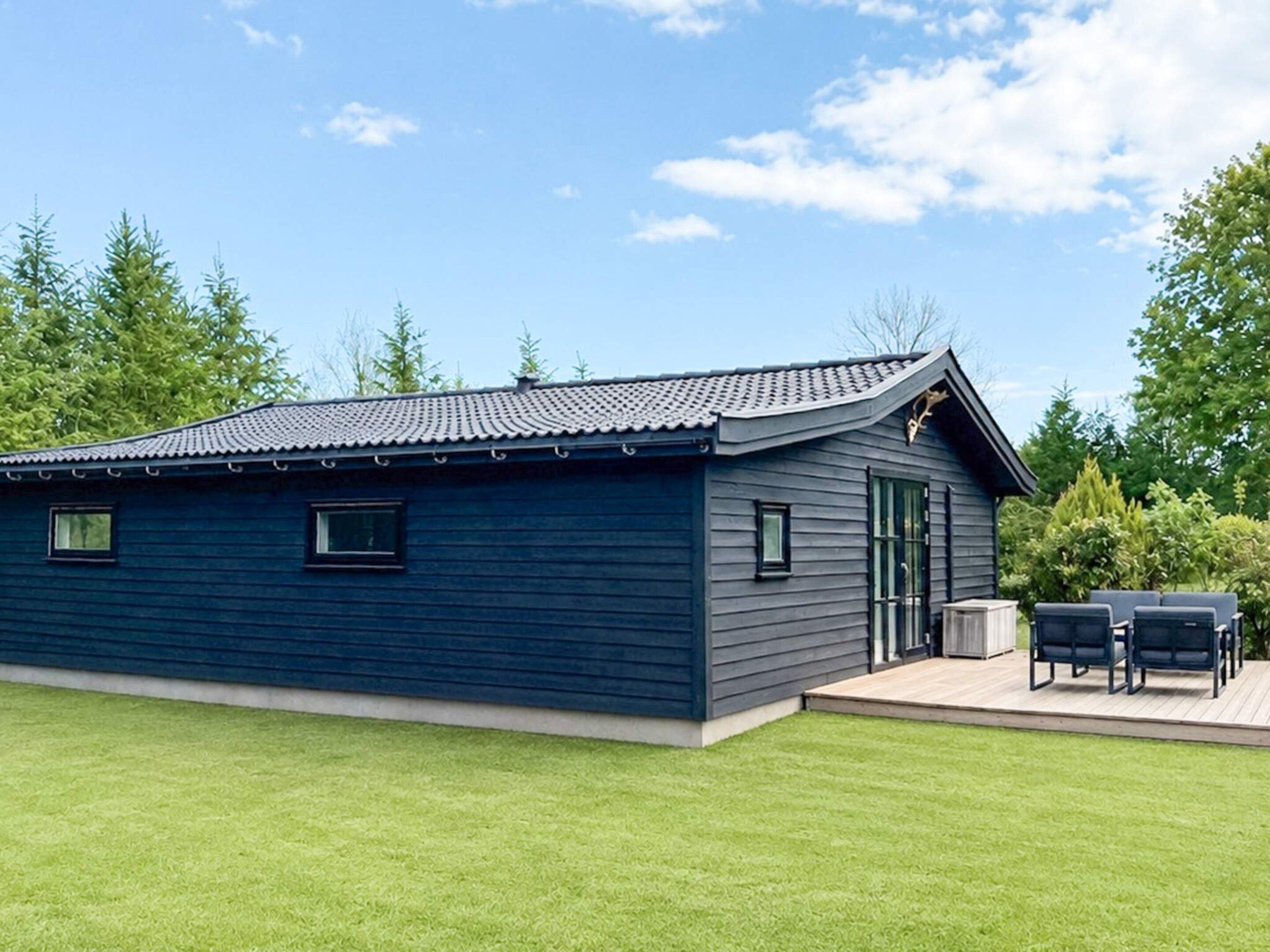 A modern building with a flat roof and a covered patio area.
