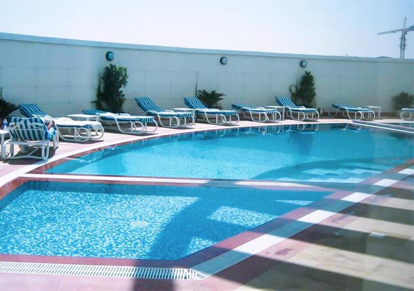 Outdoor pool, open 7:00 AM to 7:00 PM, pool loungers, lifeguards on site