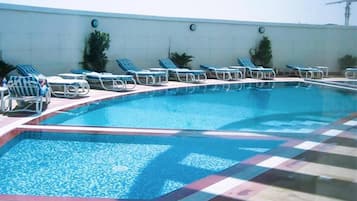 Outdoor pool, open 7:00 AM to 7:00 PM, pool loungers, lifeguards on site