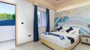 A bedroom with a bed, a nightstand, a ceiling fan, a window with curtains, and a view of greenery outside.
