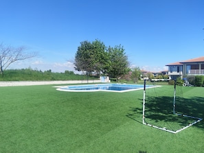 A residential area with a swimming pool, a soccer goal, and a house with a red roof. - Charming 3-bedroom house in gorgeous Balchik with AC and gym (Balchik)