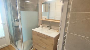 Shower, hair dryer, towels, toilet paper