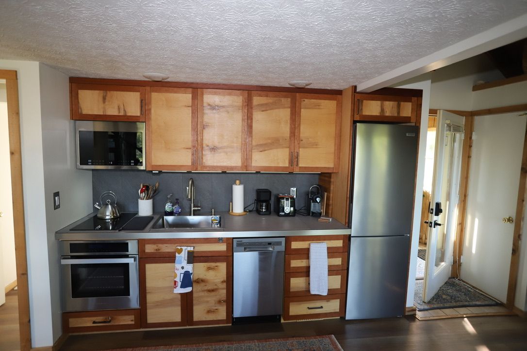 A kitchen with wooden cabinets, stainless steel appliances, and a dishwasher.