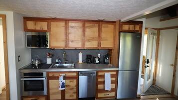 A kitchen with wooden cabinets, stainless steel appliances, and a dishwasher.