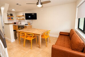 A compact living space with a dining area, kitchenette, and a sofa by a window. - Miami Havana Nights -Parking, Close to Brickell, LoanDepot (Miami)