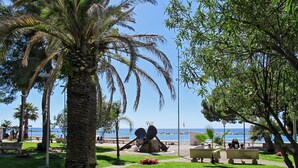 A park with palm trees, benches, and a view of the sea. - il Forno by Interhome (San Bartolomeo al Mare)