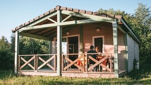 A small wooden cabin with a porch, numbered 59, surrounded by greenery. - Family Cottage for 6 in Correze (Beynat)