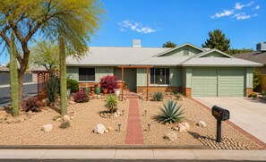 A residential house with a front porch, a mailbox, and a driveway. - Beautifully Remodeled 4BR Phoenix Desert Garden Retreat (Phoenix)