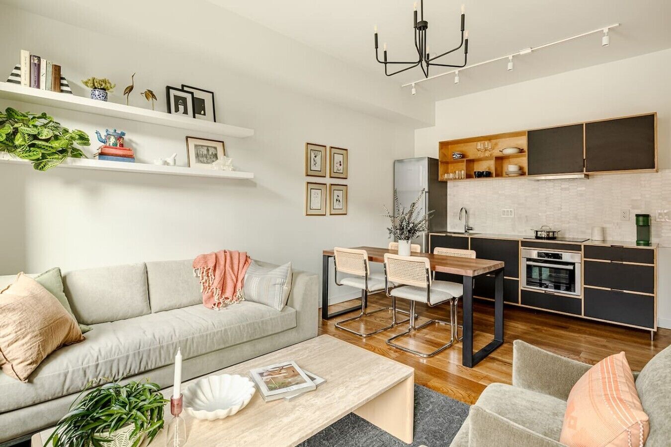 A modern living room with a sofa, coffee table, and dining area.