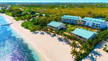 On the beach, white sand, sun-loungers, beach umbrellas