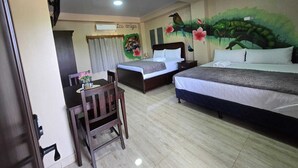 A hotel room with two beds, a desk, a chair, and a mural on the wall. - HOTEL LOS AMIGOS  (Puerto Cortés)