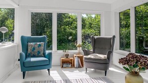 A sunlit room with two armchairs, a small table, and a bookshelf. - "Franki" - 1.8km from the sea by Interhome (Faxe)