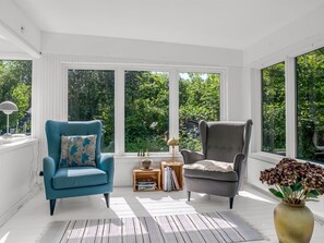 A sunlit room with two armchairs, a small table, and a bookshelf. - "Franki" - 1.8km from the sea by Interhome (Faxe)