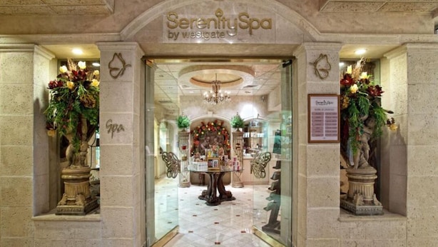 A spa entrance with a chandelier, a reception desk, and floral decorations. - Large 2-bedroom in resort near Universal Studios & Disney with water park (Orlando)