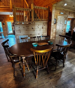 A wooden dining table with chairs, a wooden staircase, and a door labeled 'PANTRY'. - ⭐️ New ⭐️ RidgeCrest Lodge: Retreat w Mountain Views - HUGE 1st Renter Discount  (Landrum)